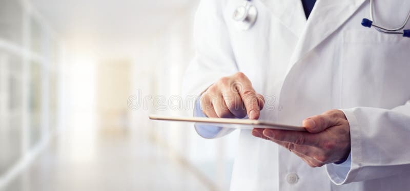 Male doctor using his digital tablet stock images
