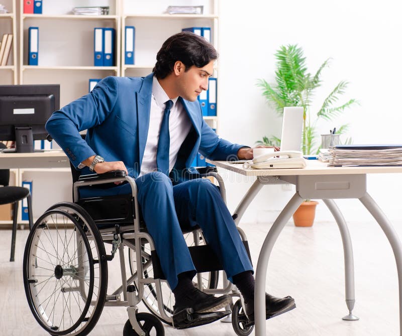 Male Employee in Wheelchair Working at the Office Stock Photo Image