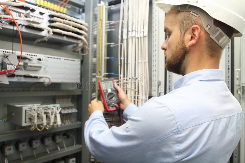 Male engineer are checking electrical system with electronic tools. stock image