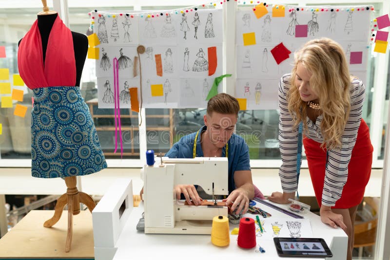 Male Fashion Designer Using Sewing Machine on a Table Stock Image ...