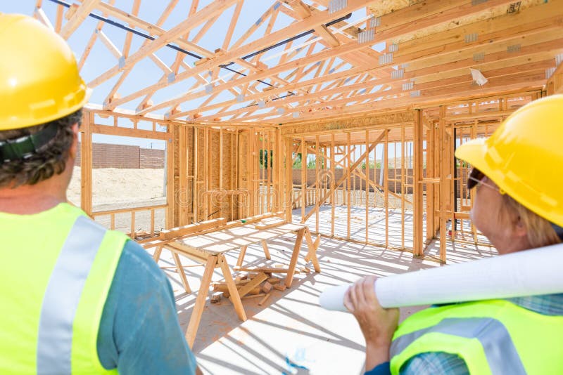Male and Female Contractors Overlooking New House Framing At Construction Site royalty free stock images Male and Female Contractors Overlooking New House Framing At Construction Site royalty free stock images