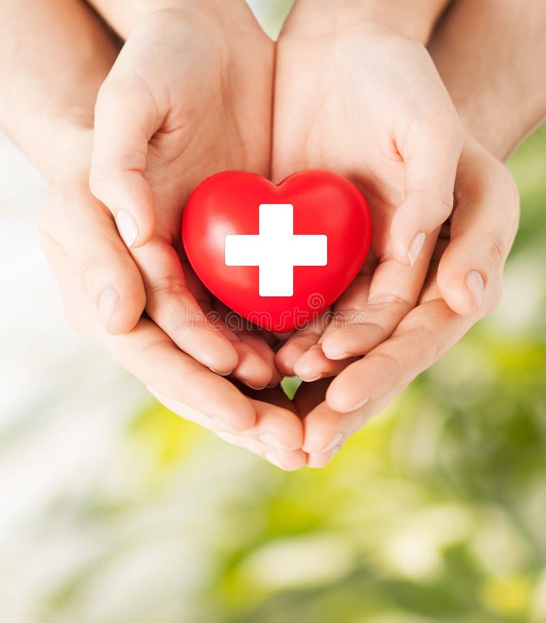 Male and female hands with red heart