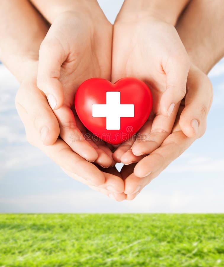 Male and female hands with red heart