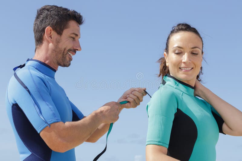 Male and Female Surfer Putting on Wetsuit Stock Image Image of surf