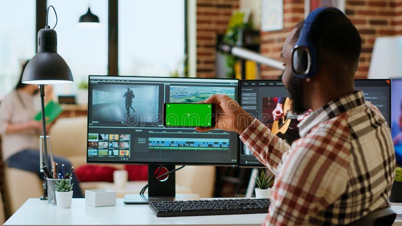 Male filmmaker editing a video project in a modern color grading software stock photography