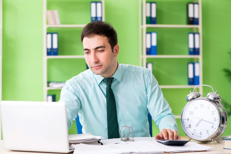 Male financial manager working in the office in time management royalty free stock image Male financial manager working in the office in time management royalty free stock image