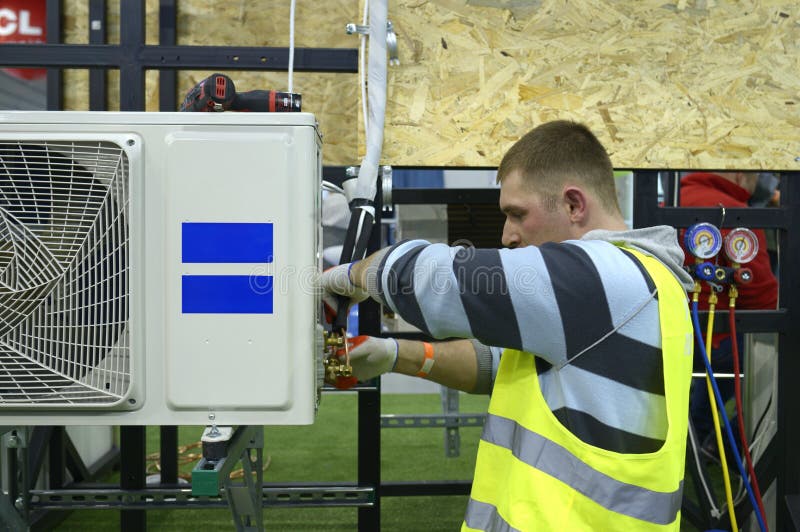 Male Fitter Assembling Air Conditioner Using Screwdriver Editorial