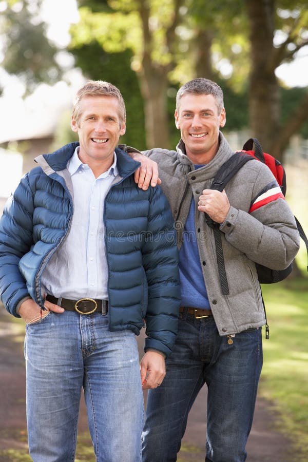 Male Friends Walking In Autumn Park