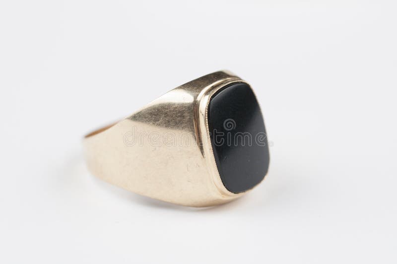 Male Golden Ring with Black Stone on a White Background Stock Photo