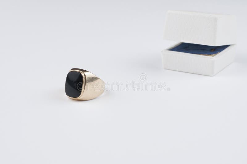 Male Golden Ring with Black Stone on a White Background Stock Image