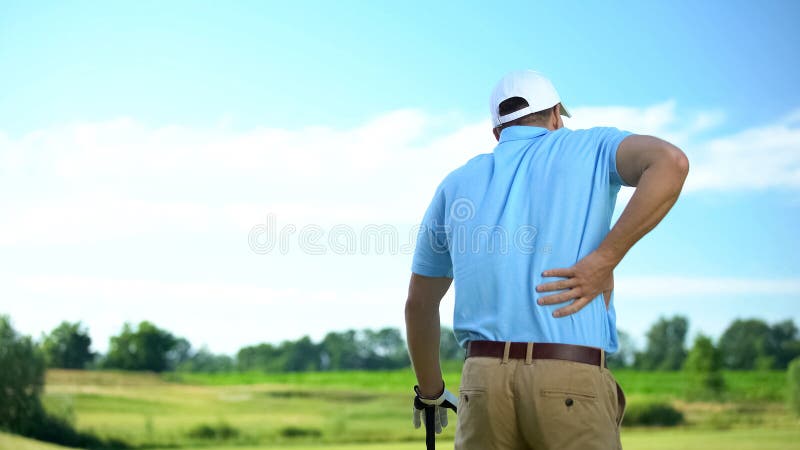 Male golf player feeling strong lower back pain after ball hitting, trauma