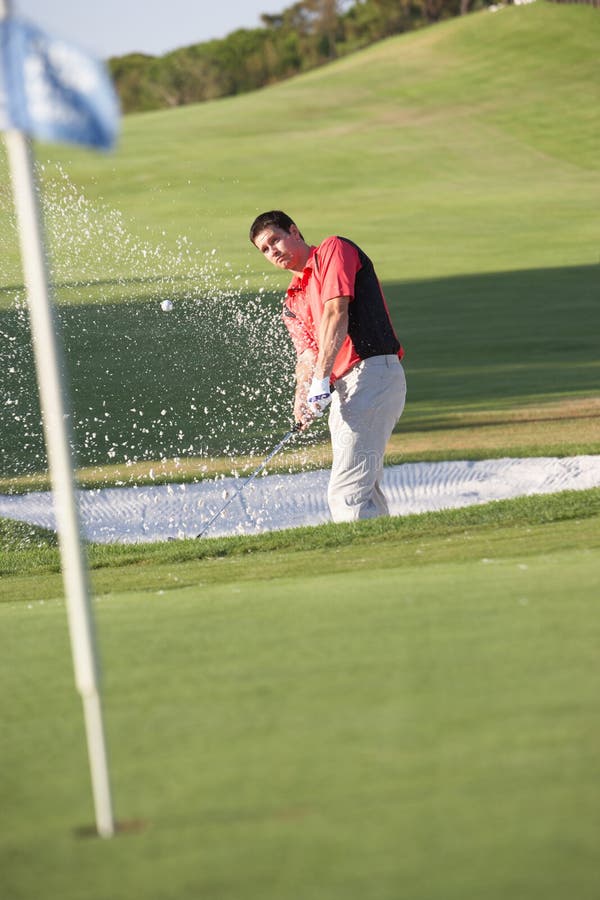 Male Golfer Playing Bunker Shot