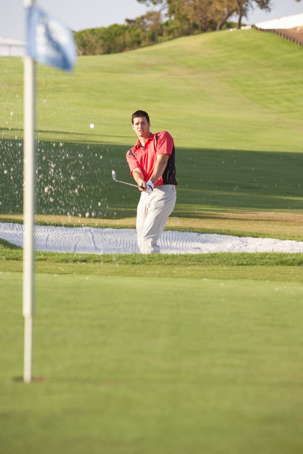 Male Golfer Playing Bunker Shot