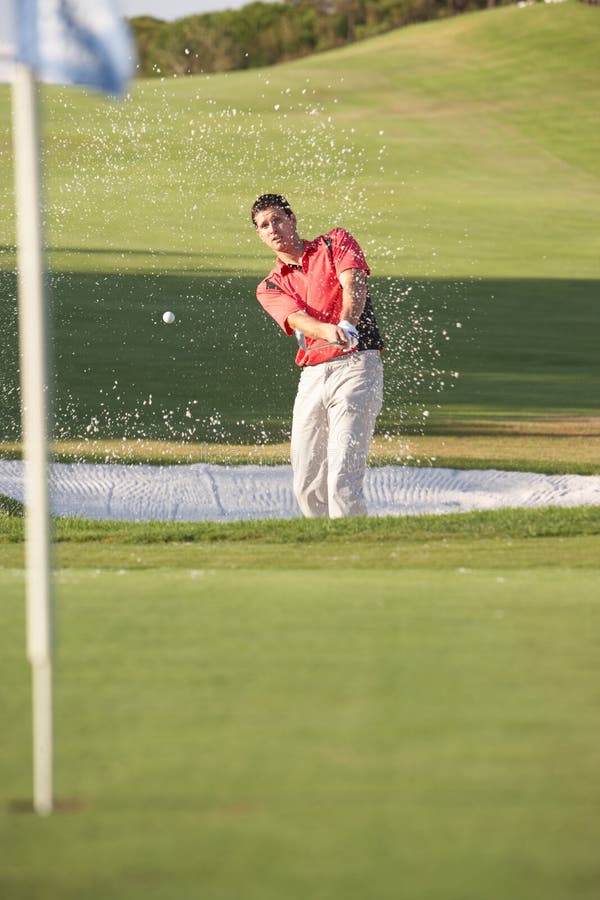 Male Golfer Playing Bunker Shot