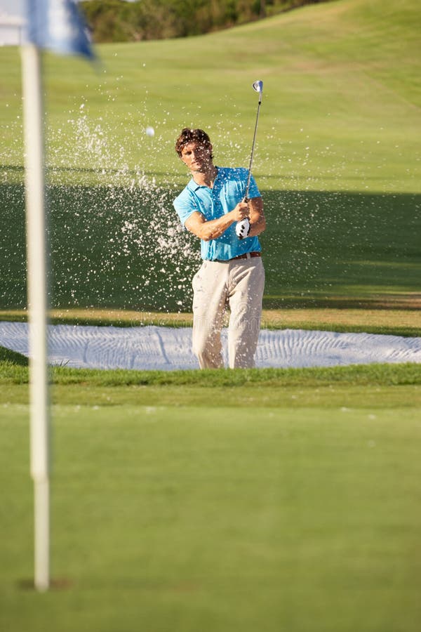 Male Golfer Playing Bunker Shot