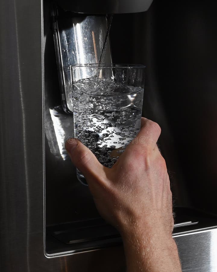 Unrecognizable Man Filling Glass From Refrigerator Water Dispenser