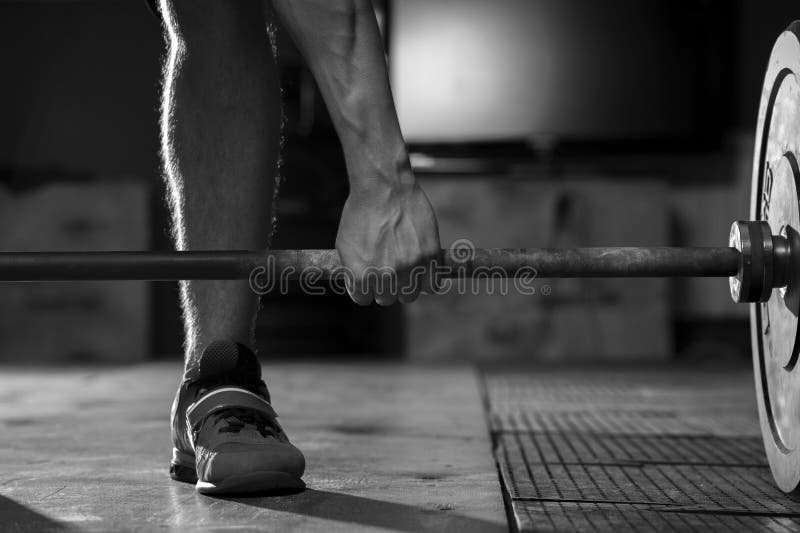 Closeup of male hand holding barbell. Strength training concept. Sports, fitness. Closeup of male hand holding barbell. Strength training concept. Sports, fitness.