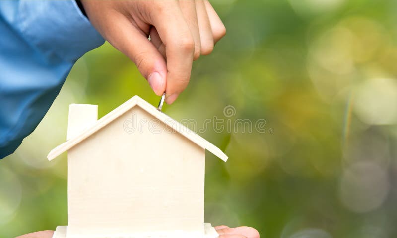Male hand holding coins and piggy house bank save money, green nature background. Investment and save Concept. royalty free stock photography Male hand holding coins and piggy house bank save money, green nature background. Investment and save Concept. royalty free stock photography