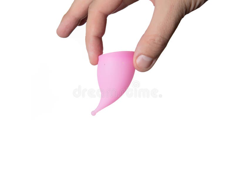A male hand holds a female vaginal cup for collecting menstruation. White background, isolate, close-up stock photos