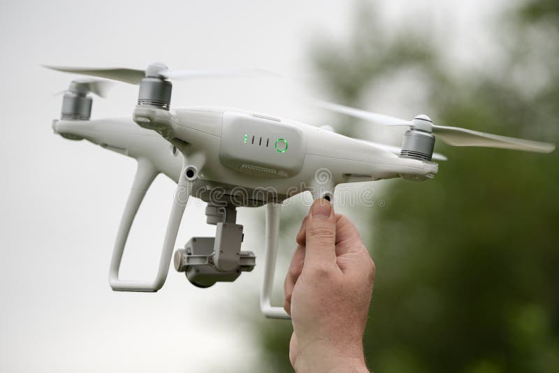 Male hand launches / catches professional drone quad copter DJI Phantom 4 Pro with digital camera 4K stock image Male hand launches / catches professional drone quad copter DJI Phantom 4 Pro with digital camera 4K stock image