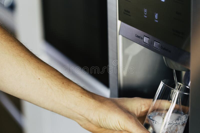 Cold water and ice cubes from dispenser of home fridge