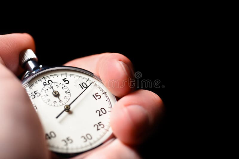 Male Hand Starts the Analog Stopwatch on a Black Background, Close ...