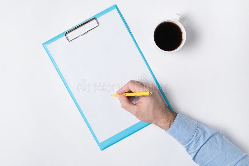 Male hand writing on paper. Top view of documents in hand and Cup of coffee. Copy space, backdrop pattern stock photography
