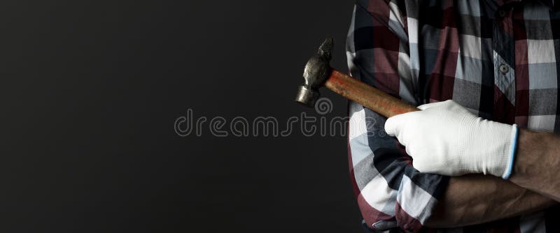 Male hands with hammer tool with black background and copy space for text. Banner royalty free stock photos