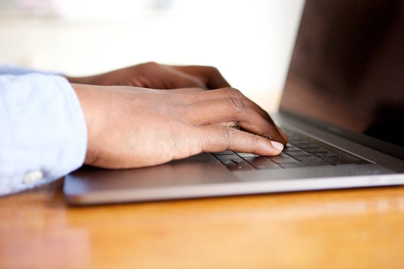 Male hands on keyboard of laptop