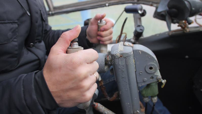 Male hands of the pilot take the steering wheel of the plane.