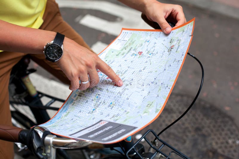 Male hands pointing on the map of Barcelona city on retro bicycle bike background.Tourism concept. Vacation.Holiday