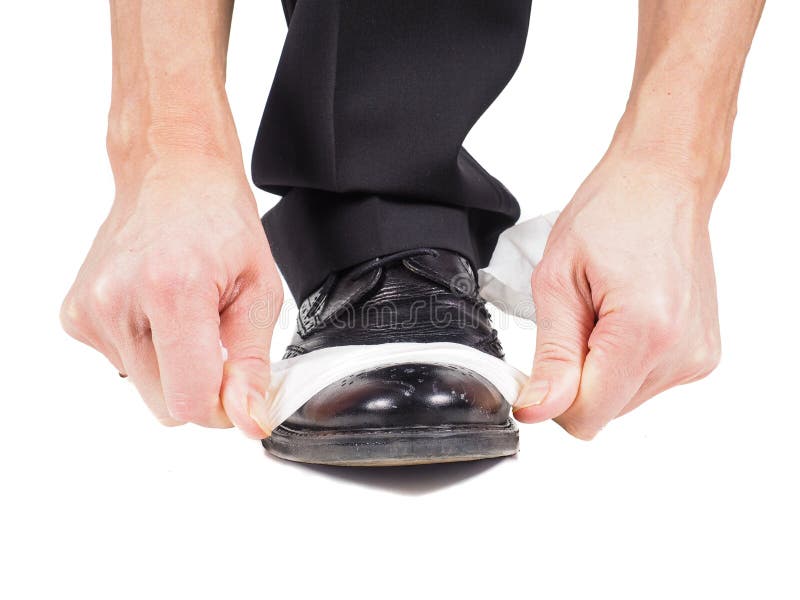 Male hands shining black leather shoes