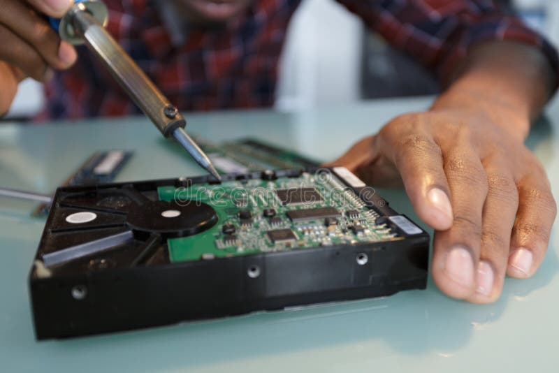 Male Hands Solder Components Onto Printed Circuit Board Stock Photo