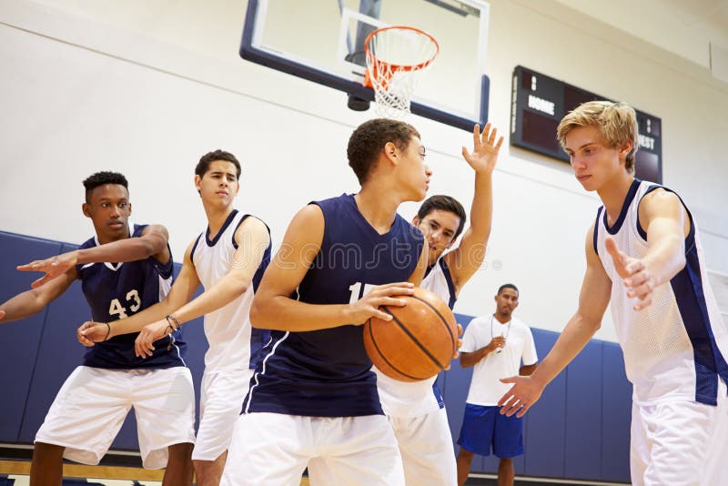 Male High School Basketball Team Playing Game stock photo Male High School Basketball Team Playing Game stock photo