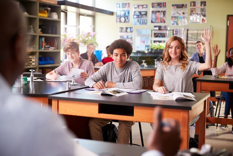 Male High School Tutor Teaching Students In Biology Class.