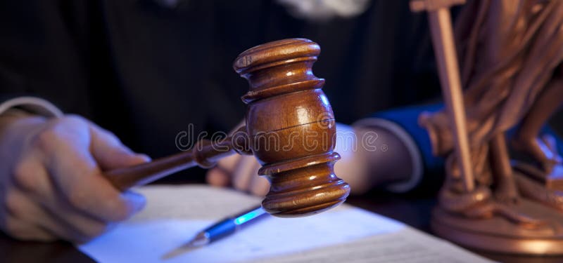 Male judge in a courtroom striking the gavel royalty free stock image Male judge in a courtroom striking the gavel royalty free stock image