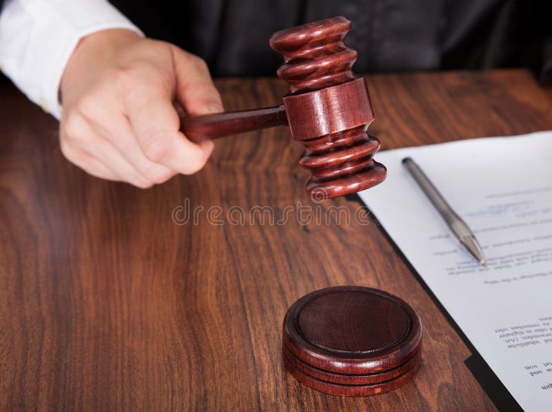 Male judge striking the gavel royalty free stock photo Male judge striking the gavel royalty free stock photo
