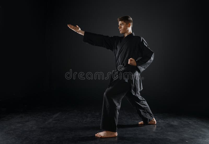 A Man, In A Black Kimono Is Practicing Martial Arts Technique With A Long  Bamboo Fighting Stick. Stock Photo, Picture and Royalty Free Image. Image  91980191.