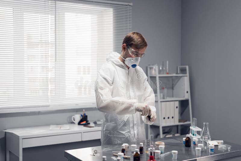 Male lab technician holding a test sample in the medical or scientific laboratory stock photo