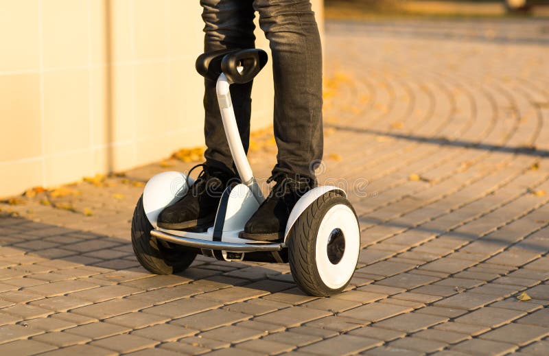 Male legs on electrical scooter outdoors gyro scooter. Move, active.