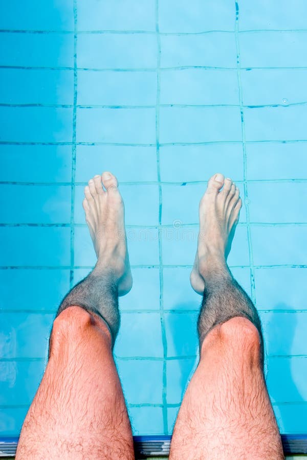 Male legs on water, by the pool. Male legs on water, by the pool.