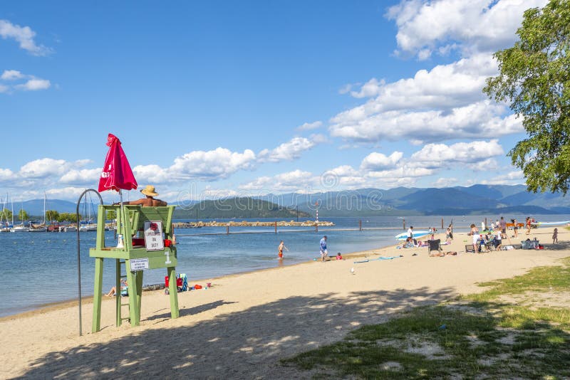 A male lifeguard sits on duty in a lifeguard station at the sandy Sandpoint Idaho City Beach along Lake Pend Oreille royalty free stock images A male lifeguard sits on duty in a lifeguard station at the sandy Sandpoint Idaho City Beach along Lake Pend Oreille royalty free stock images