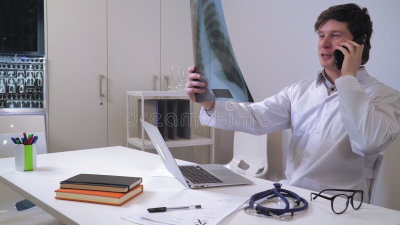 Male md talking with patient by mobile