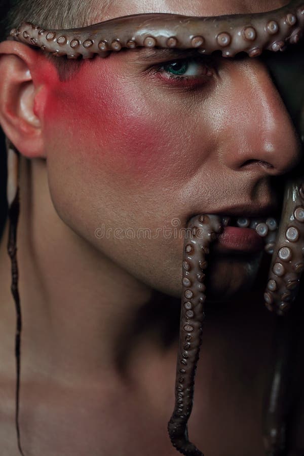 Male model close up portrait with make up and octopus, sea life concept.