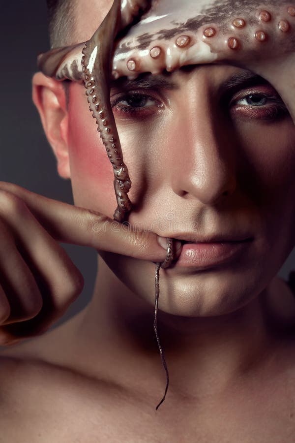 Male model close up portrait with make up and octopus, sea life concept