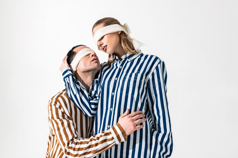 Male And Female Models Having Blindfolds And Lines On Face Stock