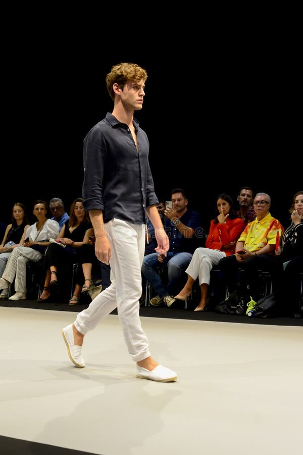 male model odel wearing black shirt trousers catwalk adlib fashion collection momad runway pants trade show 290977204