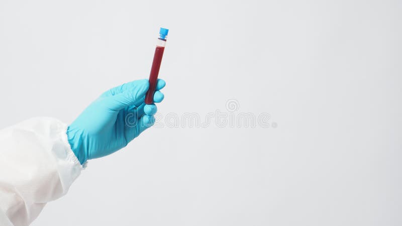 Male model with PPE suite and Hand with glove is holding blood test tube on white background royalty free stock photography Male model with PPE suite and Hand with glove is holding blood test tube on white background royalty free stock photography