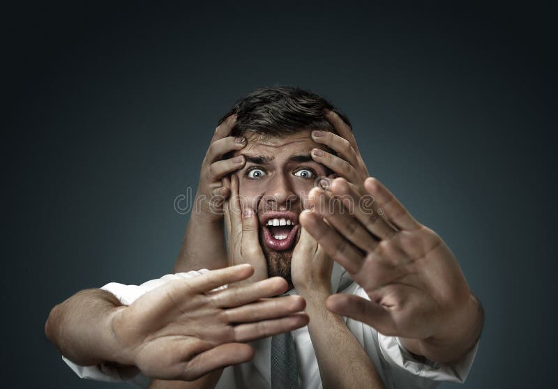 A young man surrounded by hands like his own thoughts