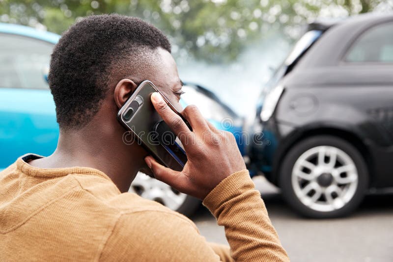 Male Motorist Involved In Car Accident Calling Insurance Company Or Recovery Service royalty free stock photo Male Motorist Involved In Car Accident Calling Insurance Company Or Recovery Service royalty free stock photo